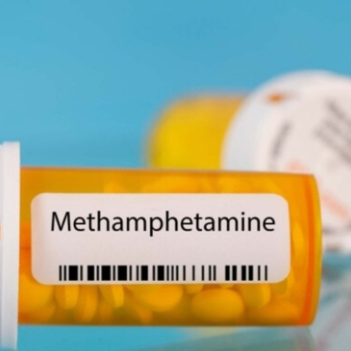 Prescription bottle labeled 'Methamphetamine' with pills