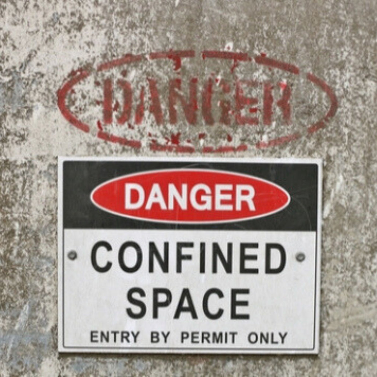 Dangerous confined space sign on a textured wall