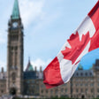 Canadian flag with parliament in the background