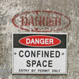 Dangerous confined space sign on a textured wall