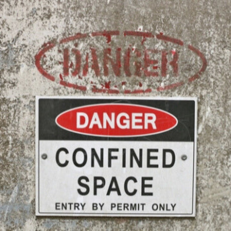 Dangerous confined space sign on a textured wall