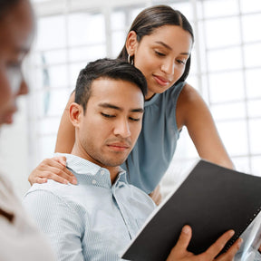 Asian man feels uncomfortable as black female touches his shoulder