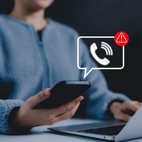 Person using a smartphone with a call red warning icon overlay