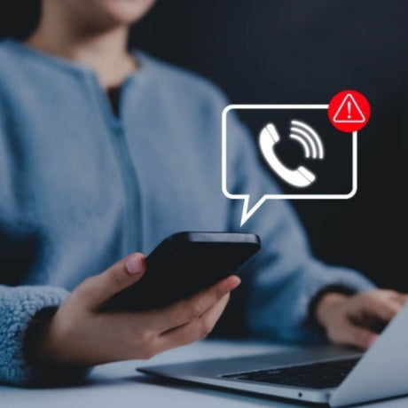 Person using a smartphone with a call red warning icon overlay