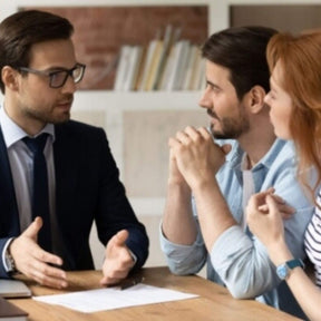 banker talking to a couple with documents