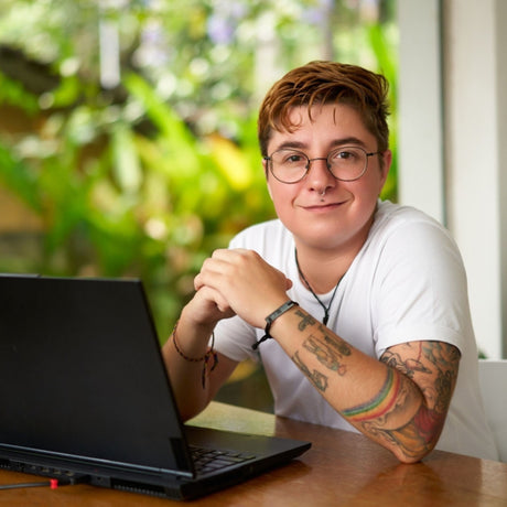 transgender man with laptop in California office